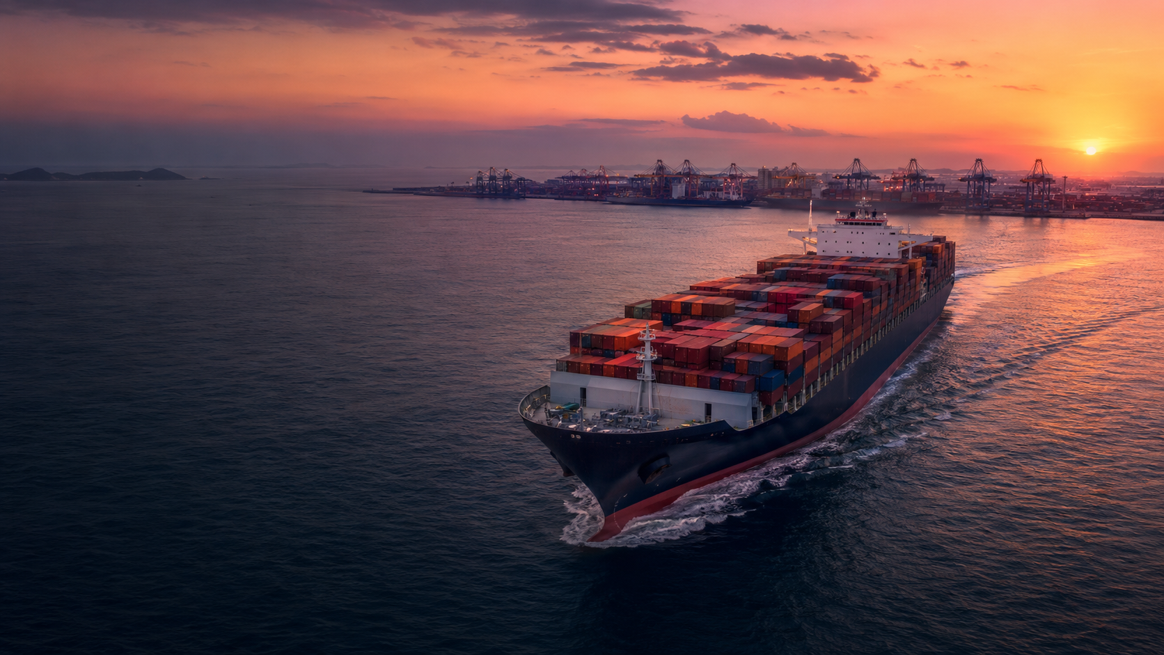 Container ship approaching a modern international seaport at sunset